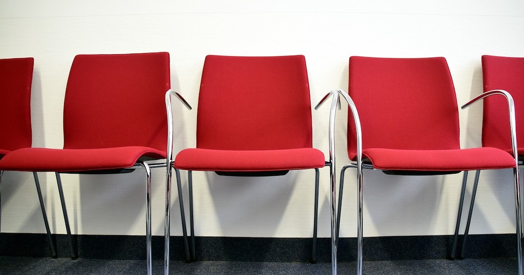 Red chairs in a waiting room.