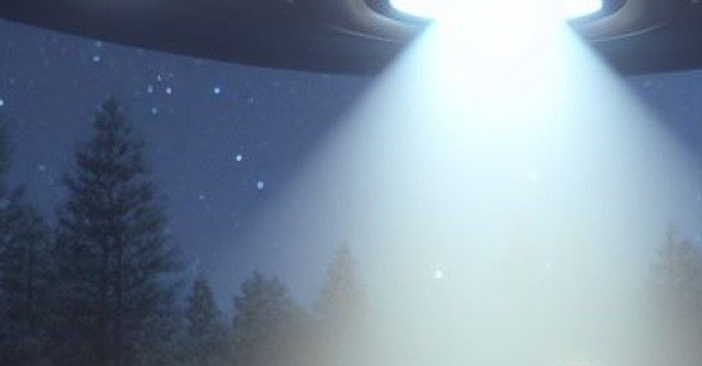 Flying saucer emits a beam of light in a forest.