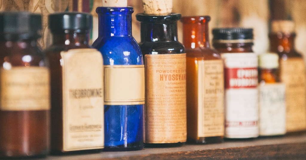 A row of antique medicine bottles.